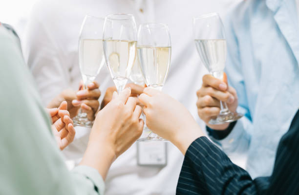 Group Asian business people are having a toast together and chatting at a company party